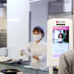 An employee using LG CNS's "face recognition community currency" system.